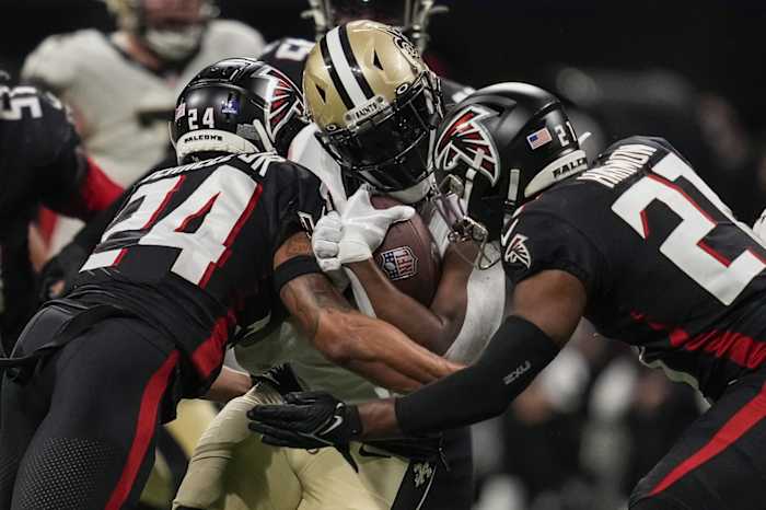 Jan 9, 2022; New Orleans Saints running back Alvin Kamara (41) is tackled by Atlanta Falcons cornerback A.J. Terrell (24) and safety Richie Grant (27). Mandatory Credit: Dale Zanine-USA TODAY Sports
